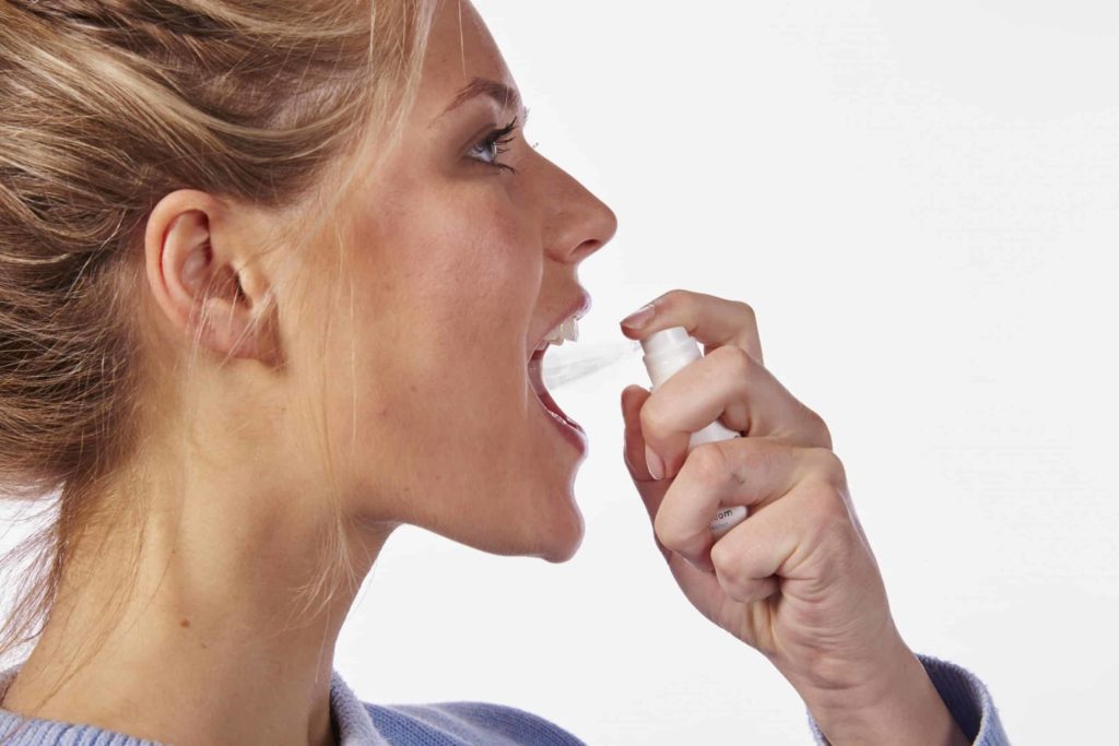 woman with bluem mouthspray
